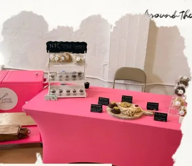 Chapter Azúcar pop-up table dressed in pink with a NYC Style Cookies chalkboard sign